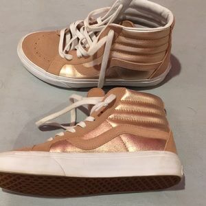Pink/holographic high tops Vans.